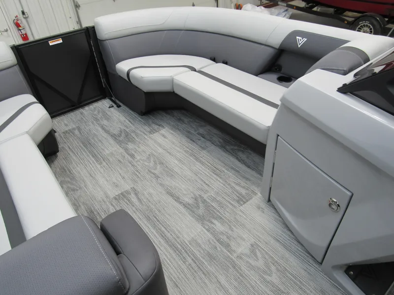 Slide: The Image of 2025 Viaggio Lago X22C boat interior with gray seating and wood-style flooring. - 7