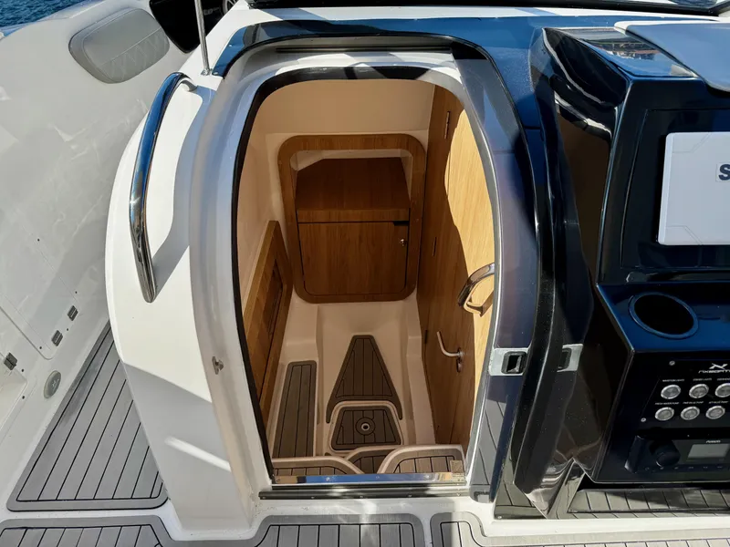 Slide: The Image of 2024 NX Boats 280 Xtreme cabin interior with wood accents and modern design. - 15