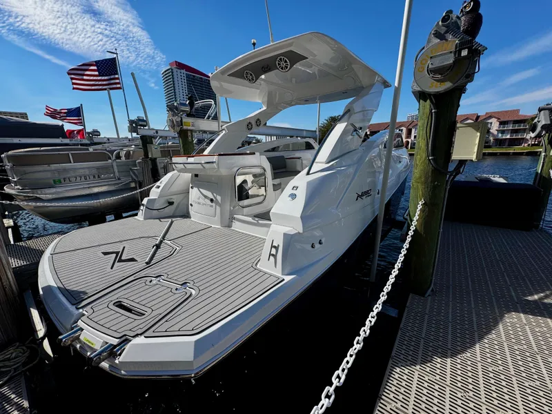 Slide: The Image of 2024 NX Boats 280 Xtreme docked, showcasing sleek design and modern features. - 2