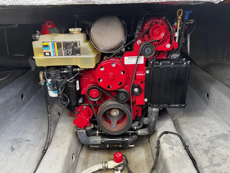 Slide: The Image of Engine compartment of 2024 NX Boats 280 Xtreme, showcasing a red marine engine. - 20