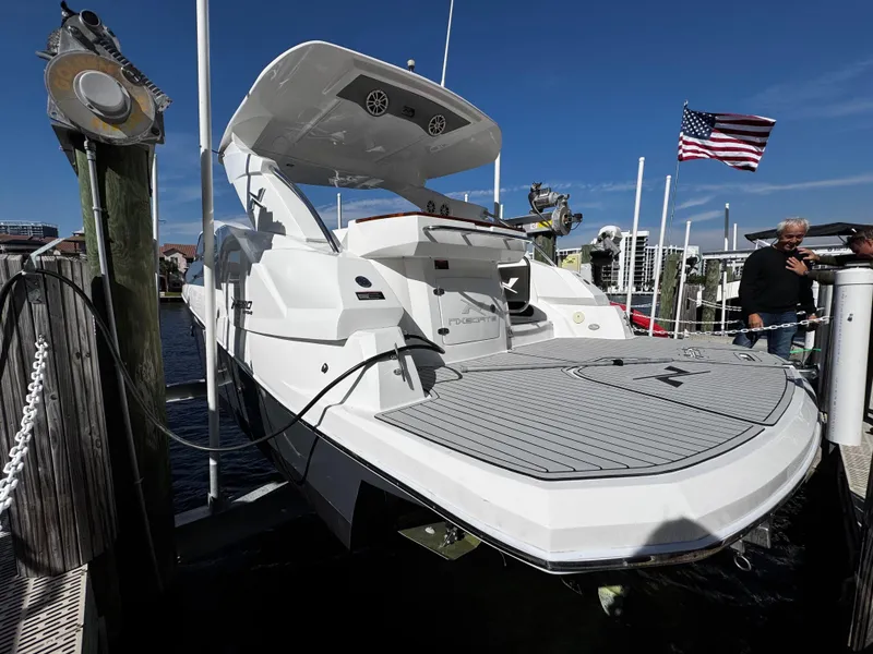 Slide: The Image of 2024 NX Boats 280 Xtreme docked, showcasing sleek design and spacious deck. - 3