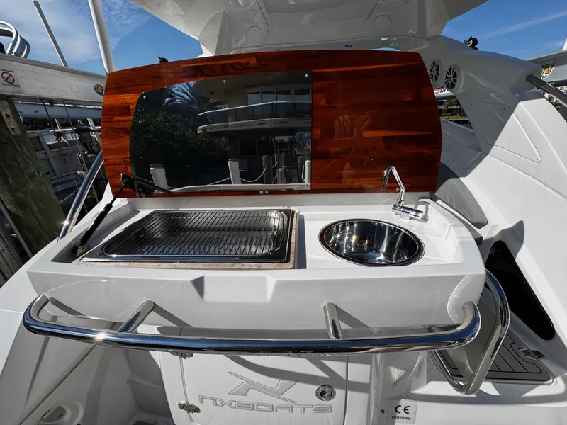 Slide: The Image of 2024 NX Boats 280 Xtreme outdoor kitchen with sink and grill. - 5