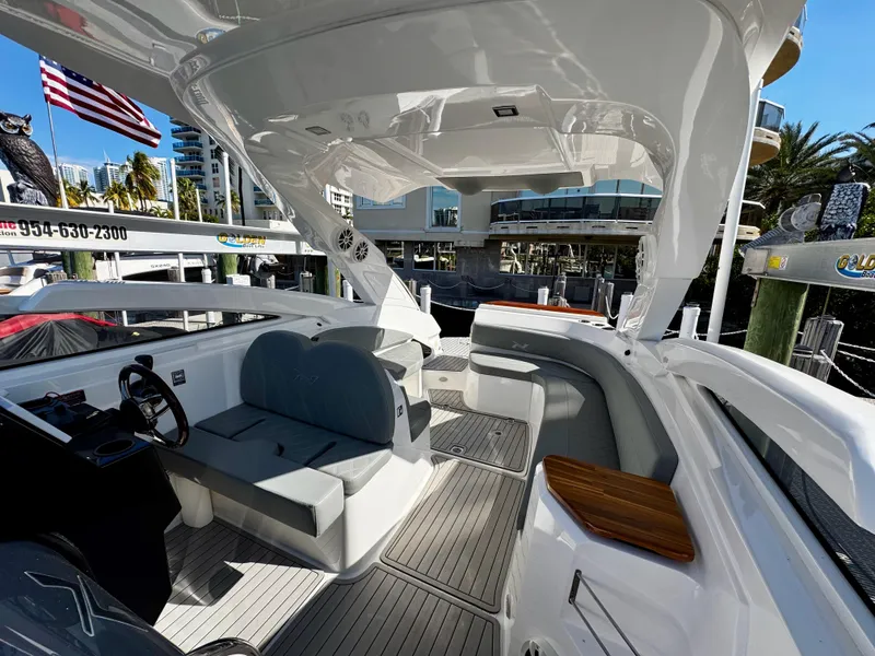 Slide: The Image of 2024 NX Boats 280 Xtreme interior with sleek seating and modern design in a marina setting. - 8