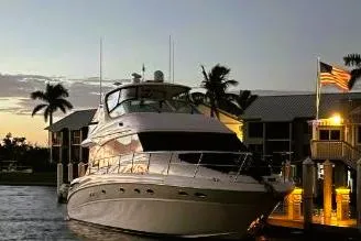 The Image of 2001 Sea Ray 540 Cockpit Motor Yacht docked at sunset with palm trees. - 0