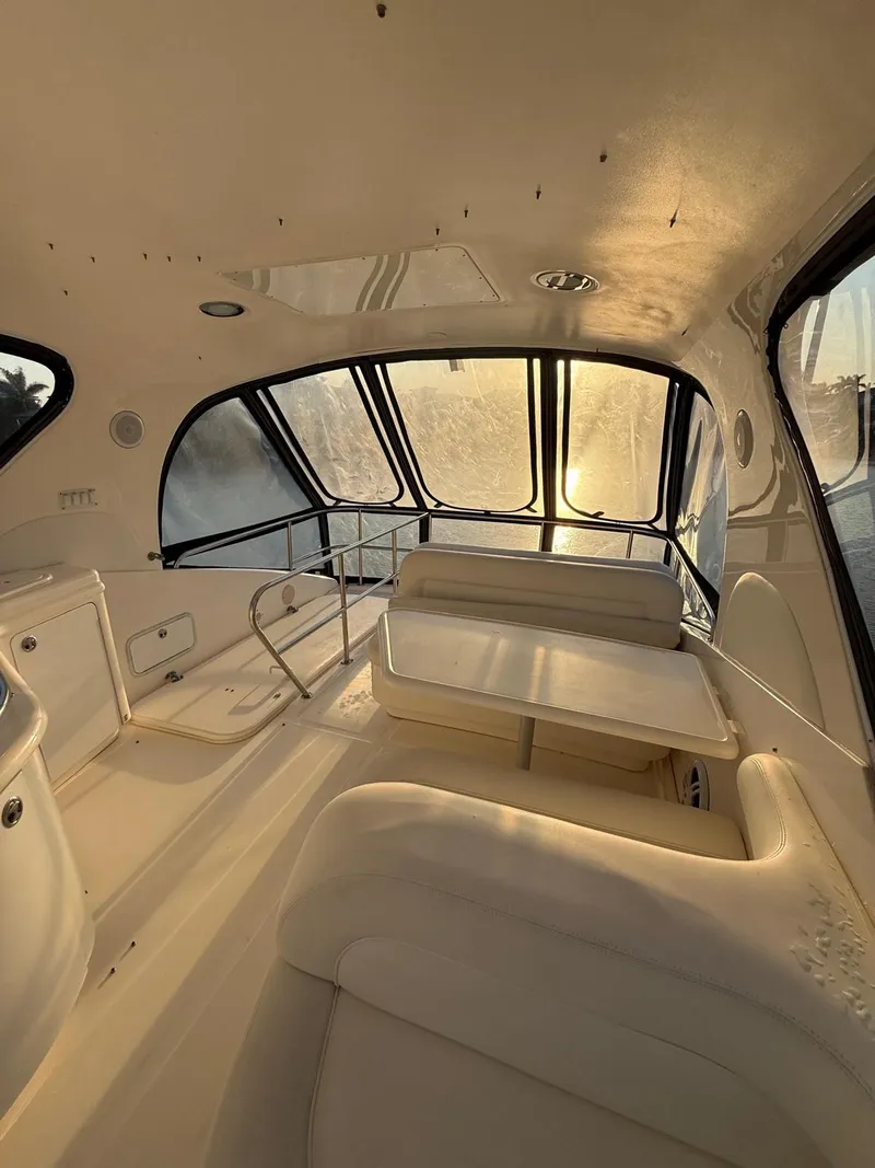 Slide: The Image of Interior of 2001 Sea Ray 540 Cockpit Motor Yacht with sunlit seating area. - 13