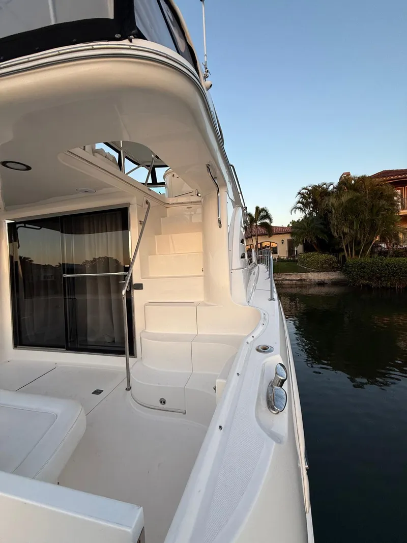 Slide: The Image of 2001 Sea Ray 540 Cockpit Motor Yacht docked by waterfront homes. - 15