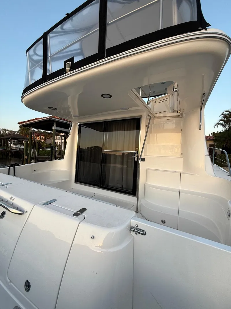 Slide: The Image of 2001 Sea Ray 540 Cockpit Motor Yacht, rear view, showcasing sleek design and spacious deck. - 17