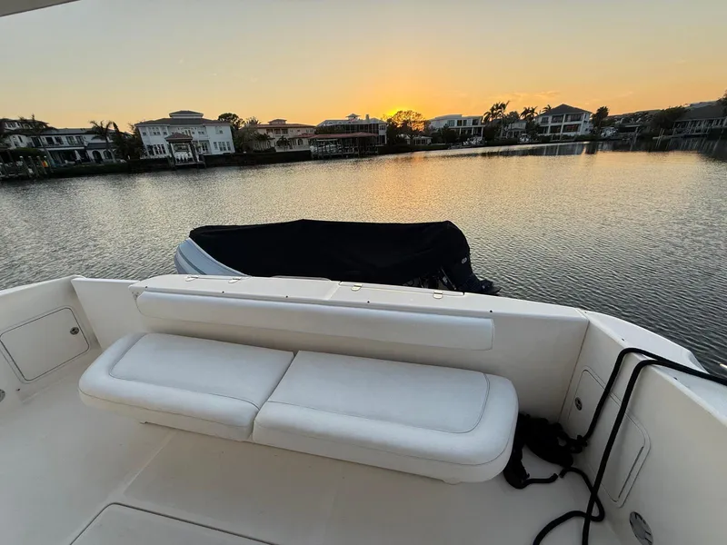 Slide: The Image of 2001 Sea Ray 540 Cockpit Motor Yacht at sunset, overlooking serene waterfront homes. - 19