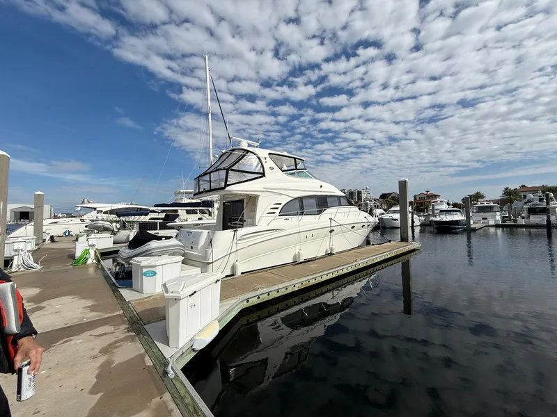 Slide: The Image of 2001 Sea Ray 540 Cockpit Motor Yacht docked at marina under cloudy sky. - 2