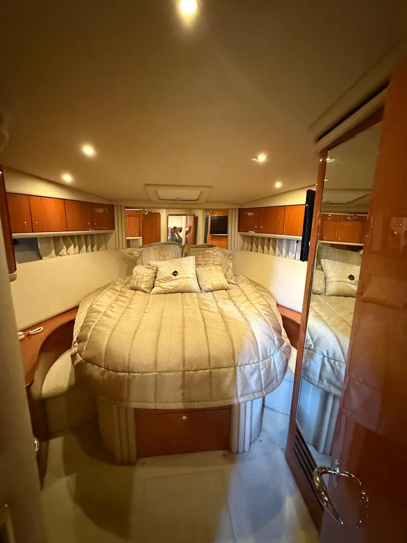 Slide: The Image of Luxurious bedroom interior of 2001 Sea Ray 540 Cockpit Motor Yacht with plush bedding. - 21