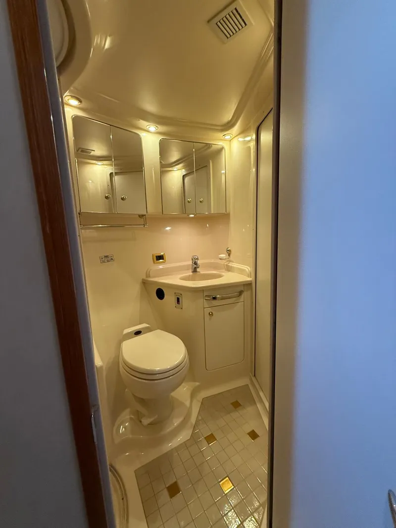 Slide: The Image of 2001 Sea Ray 540 Cockpit Motor Yacht bathroom with modern fixtures and elegant lighting. - 24