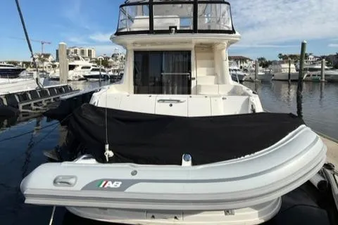 Slide: The Image of 2001 Sea Ray 540 Cockpit Motor Yacht docked with inflatable boat. - 3