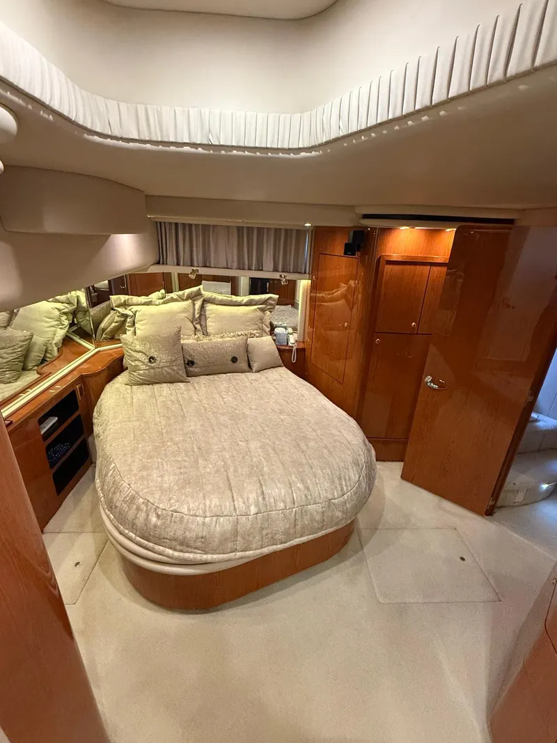 Slide: The Image of Luxurious bedroom interior of 2001 Sea Ray 540 Cockpit Motor Yacht with plush bedding. - 31