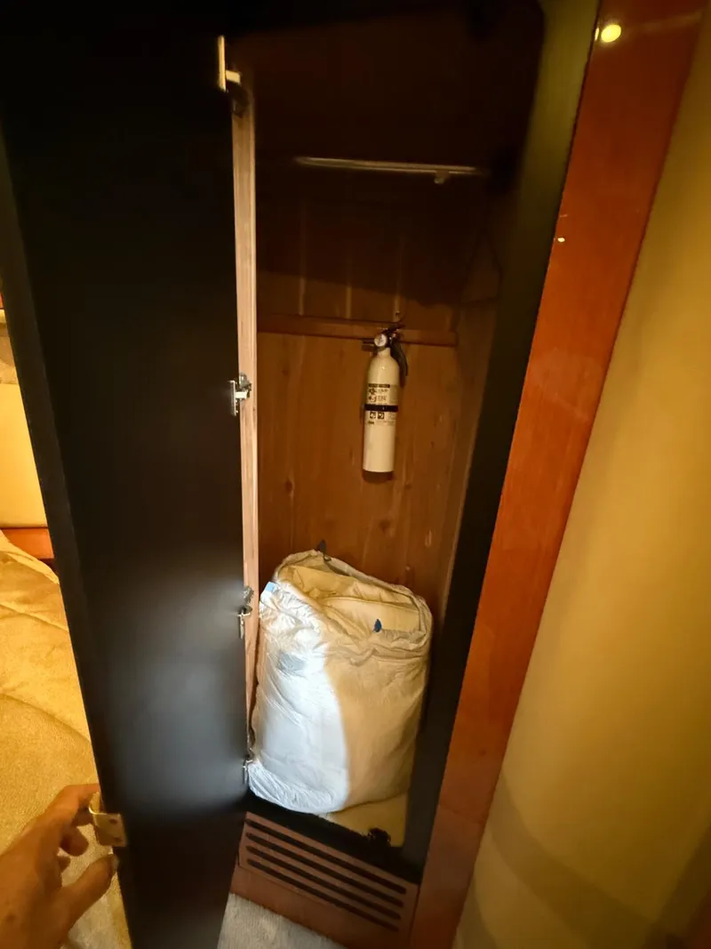 Slide: The Image of 2001 Sea Ray 540 Cockpit Motor Yacht interior closet with fire extinguisher and bag. - 34