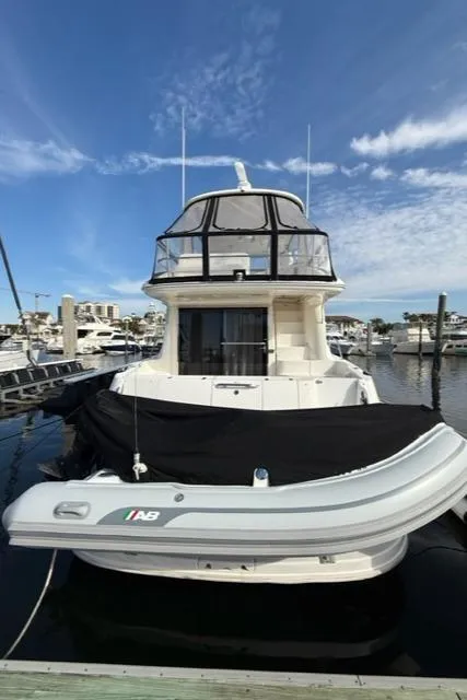 Slide: The Image of 2001 Sea Ray 540 Cockpit Motor Yacht docked with inflatable boat. - 4