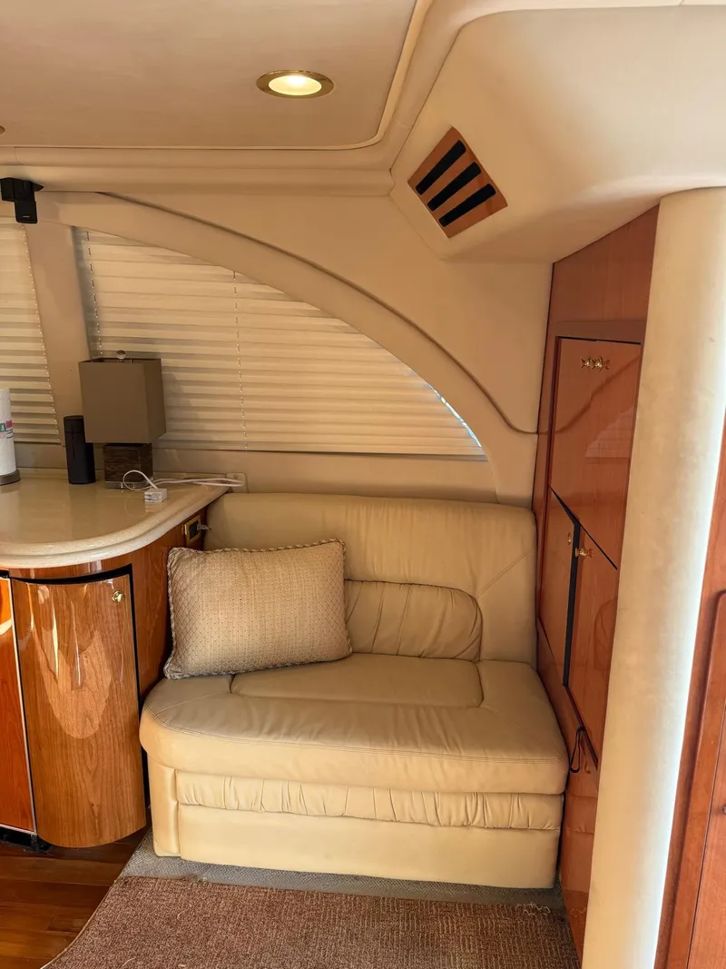 Slide: The Image of Interior of 2001 Sea Ray 540 Cockpit Motor Yacht with beige seating and wooden cabinetry. - 8