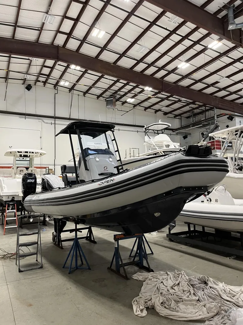 Slide: The Image of 2024 Zodiac Open 6.5 boat in a warehouse on stands. - 1