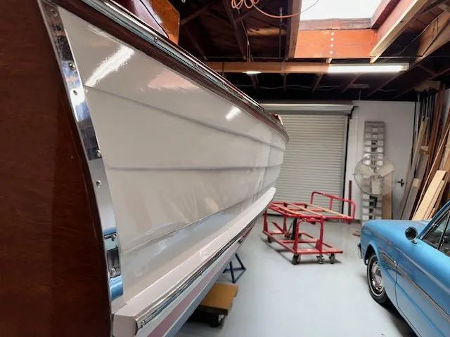 Slide: The Image of 1956 Custom South Coast Boatyard vessel in garage, alongside a vintage blue car. - 7