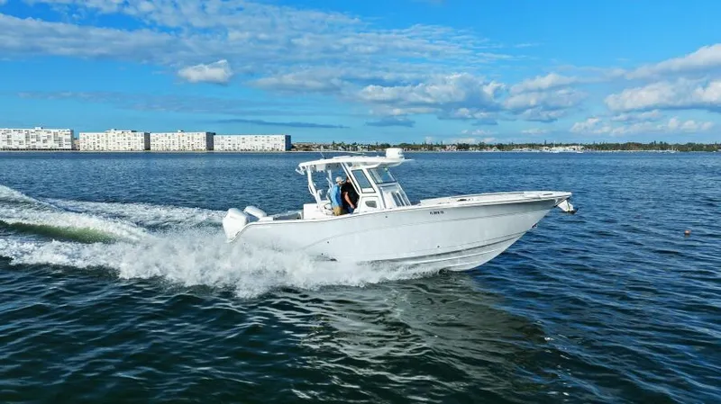 Slide: The Image of 2024 Sea Fox 328 Commander cruising on open water under a clear blue sky. - 1