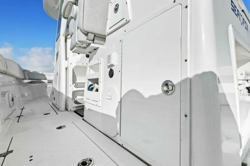 Slide: The Image of 2024 Sea Fox 328 Commander boat deck with storage compartments and seating. - 10