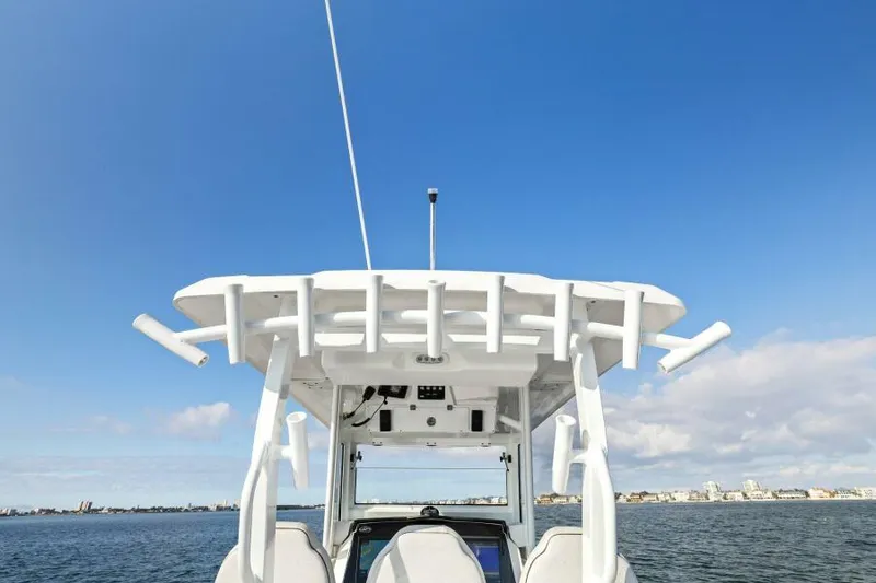 Slide: The Image of 2024 Sea Fox 328 Commander boat on open water under clear blue sky. - 13