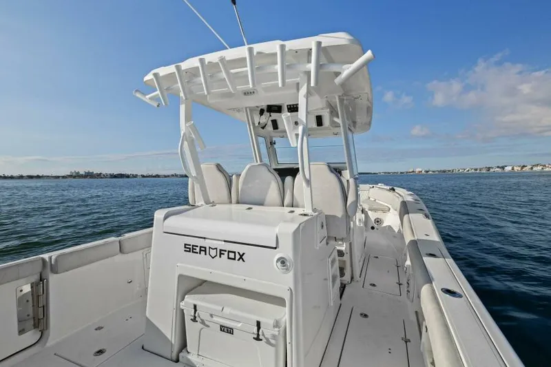 Slide: The Image of 2024 Sea Fox 328 Commander boat on open water, featuring spacious deck and seating. - 16