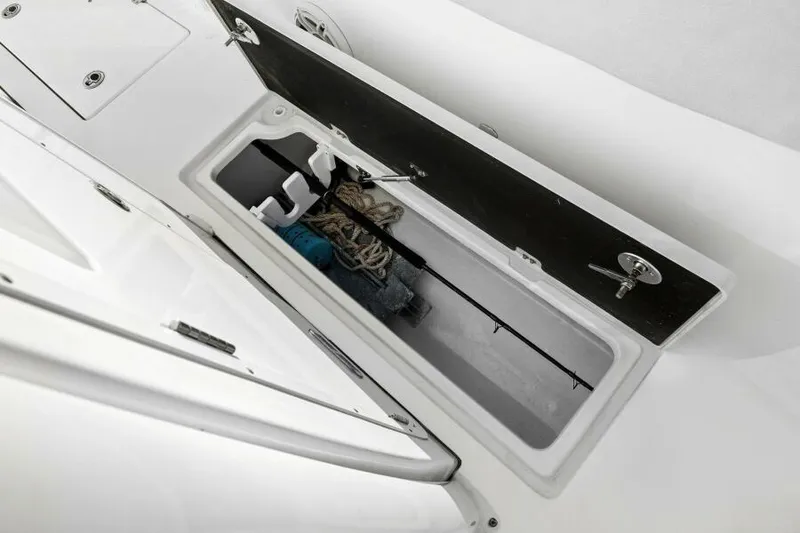 Slide: The Image of 2024 Sea Fox 328 Commander storage compartment with fishing gear and ropes. - 17
