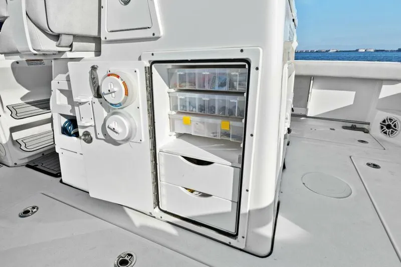 Slide: The Image of 2024 Sea Fox 328 Commander fishing tackle storage with organized compartments on deck. - 19
