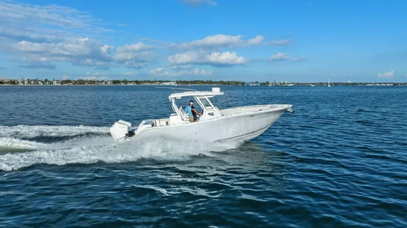 Slide: The Image of 2024 Sea Fox 328 Commander cruising on open water under a clear blue sky. - 38