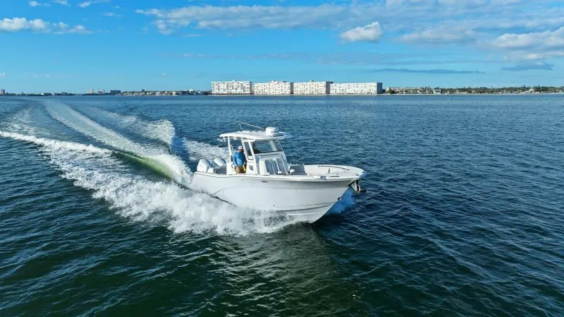 Slide: The Image of 2024 Sea Fox 328 Commander cruising on open water under a clear blue sky. - 40