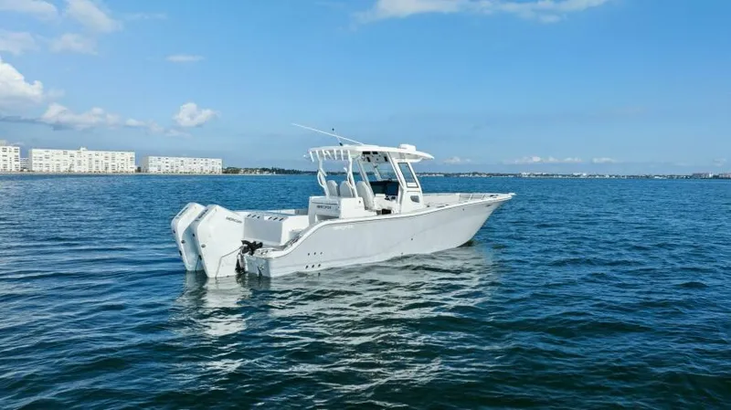 Slide: The Image of 2024 Sea Fox 328 Commander boat on calm ocean waters under clear blue sky. - 45