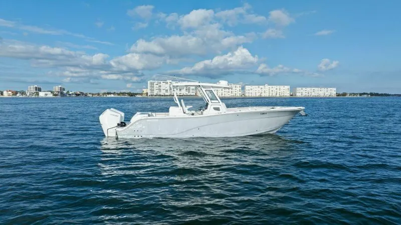 Slide: The Image of 2024 Sea Fox 328 Commander boat on open water with cityscape background. - 46