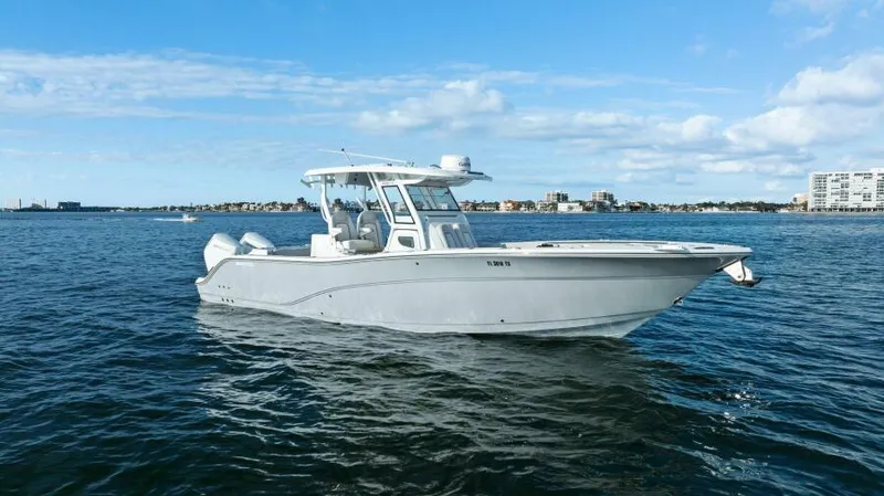 Slide: The Image of 2024 Sea Fox 328 Commander boat on open water under blue sky. - 47