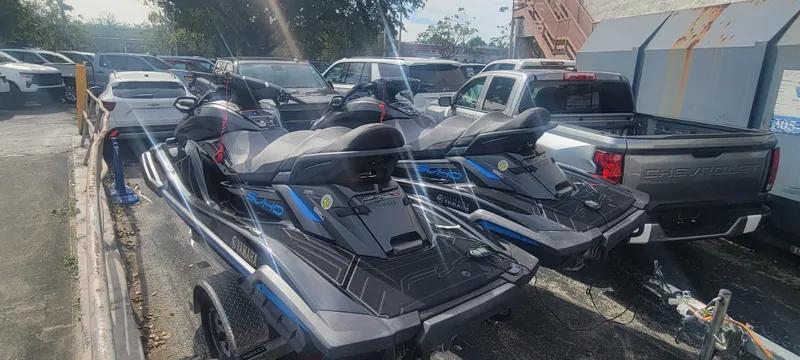 Slide: The Image of 2020 Yamaha WaveRunner FX Cruiser SVHO jet skis parked on a trailer in a lot. - 5