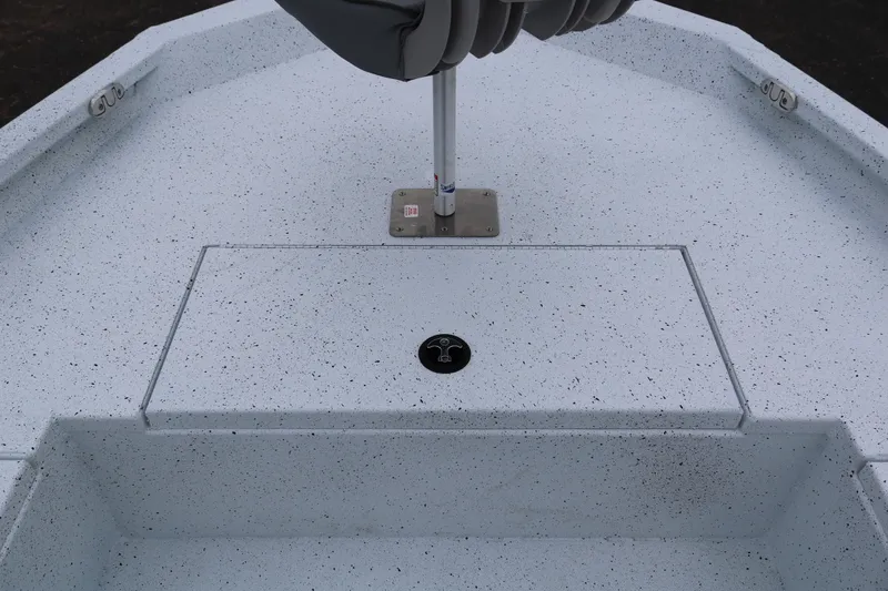 Slide: The Image of 2025 Xpress H20B boat interior with speckled flooring and seat base. - 12