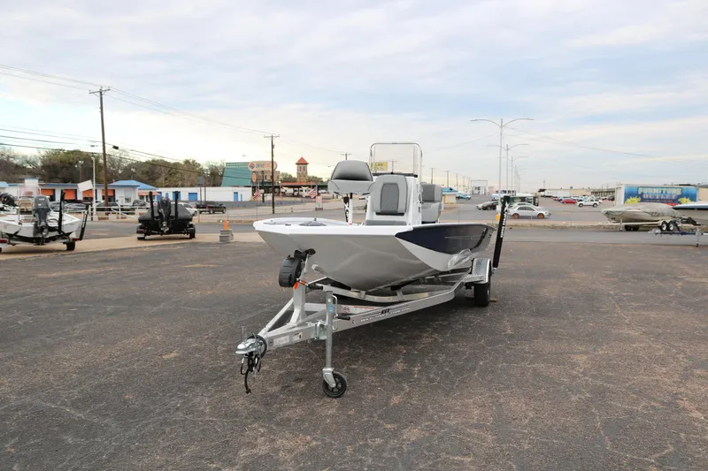 Slide: The Image of 2025 Xpress H20B boat on trailer in parking lot, ready for transport. - 2