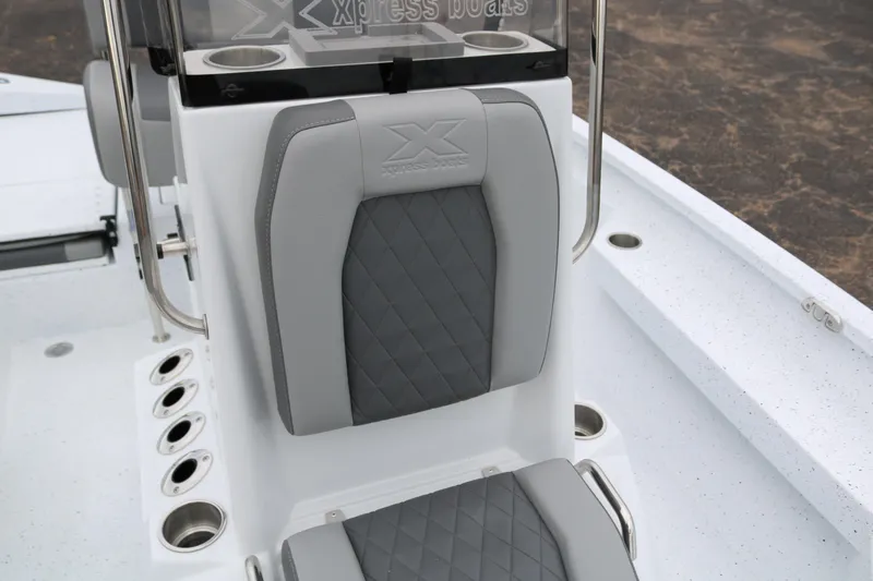 Slide: The Image of 2025 Xpress H20B boat seat with gray upholstery and cup holders. - 20