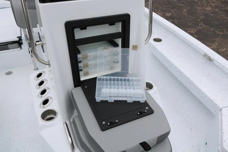 Slide: The Image of 2025 Xpress H20B boat console with tackle storage and rod holders. - 21