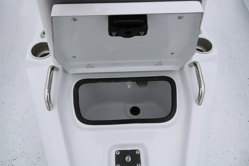 Slide: The Image of Open storage compartment on 2025 Xpress H20B boat with cup holders and handles. - 23