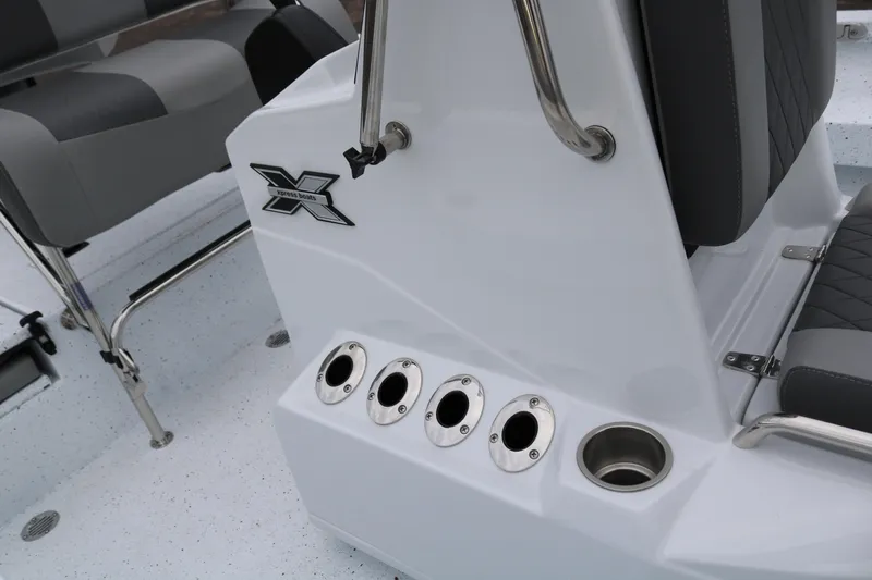 Slide: The Image of 2025 Xpress H20B boat interior with rod holders and seating. - 24