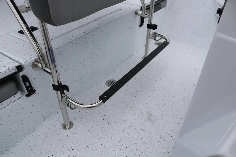 Slide: The Image of 2025 Xpress H20B boat interior with stainless steel footrest and speckled flooring. - 32
