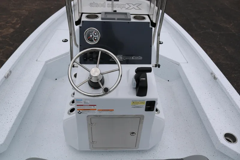 Slide: The Image of 2025 Xpress H20B boat console with steering wheel and controls. - 33