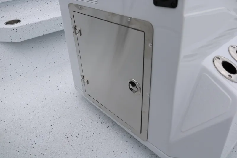 Slide: The Image of 2025 Xpress H20B boat storage compartment with stainless steel door on speckled deck. - 34