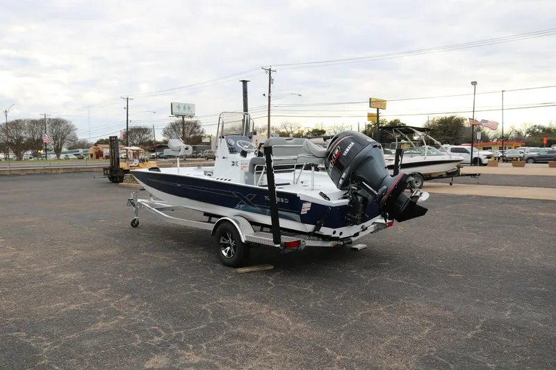 Slide: The Image of 2025 Xpress H20B boat on trailer in parking lot, rear view. - 4