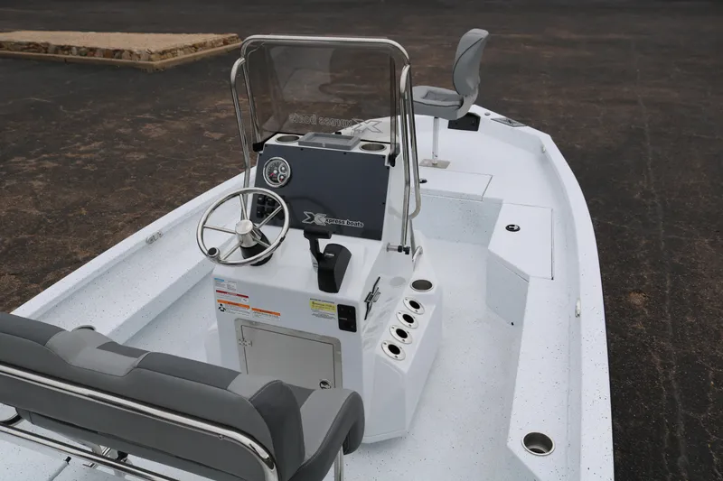 Slide: The Image of 2025 Xpress H20B boat interior with steering console and seating. - 7