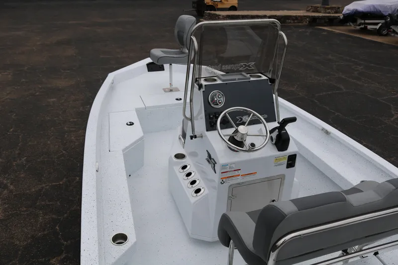 Slide: The Image of 2025 Xpress H20B boat interior with steering console and seating. - 8