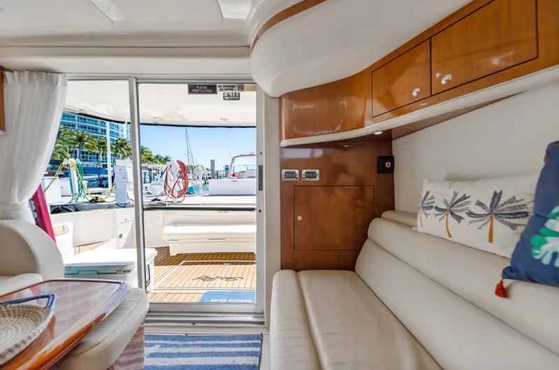 Slide: The Image of Interior of 2003 Sea Ray 400 Sedan Bridge yacht, featuring elegant seating and wood cabinetry. - 13