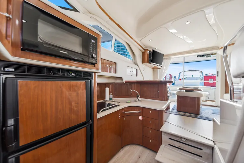 Slide: The Image of Interior of 2003 Sea Ray 400 Sedan Bridge yacht with kitchen and seating area. - 19