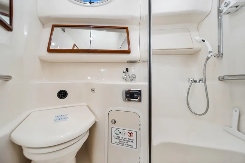 Slide: The Image of 2003 Sea Ray 400 Sedan Bridge bathroom with shower, toilet, and mirror. - 22