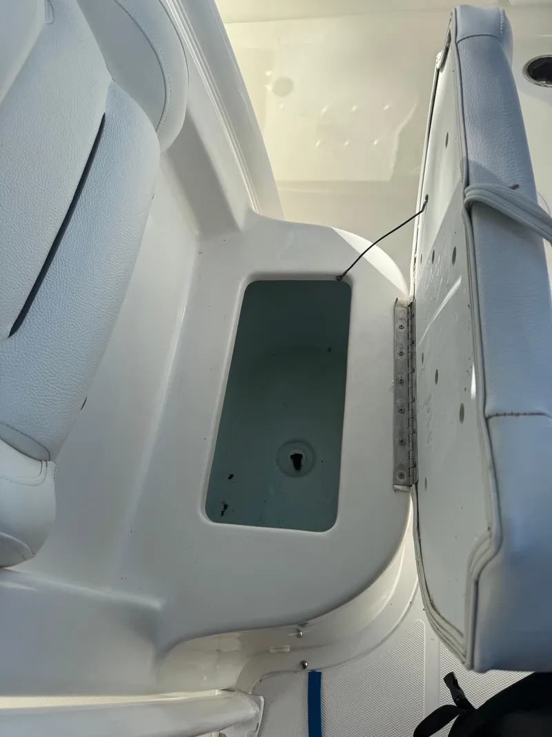 Slide: The Image of 2015 Sea Hunt Ultra 234 boat storage compartment with open seat. - 11
